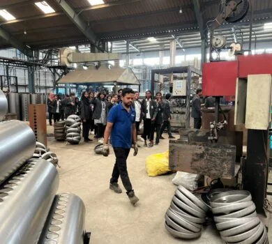A guide walking students through the factory floor, explaining the machinery and processes.